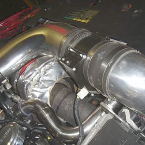 PIC he sent me of the kit on his car, can anyone tell me what that metal black thing is with the wires coming out? Obviously thats why the intake tube