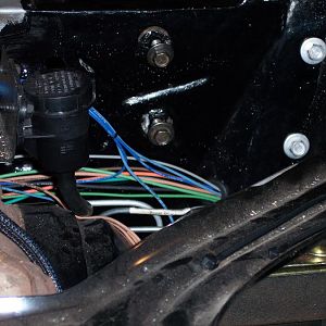 1/12/18 I drilled a 7/8" hole in the l/s rear inner fender panel just below & forward of the hood hinge & ran the harness through a grommet out under